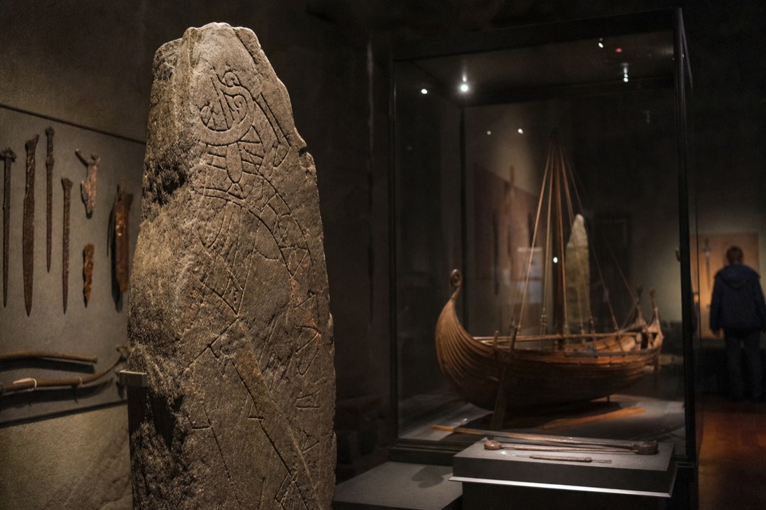Reconstructed Viking longship timbers in a museum hall by the water