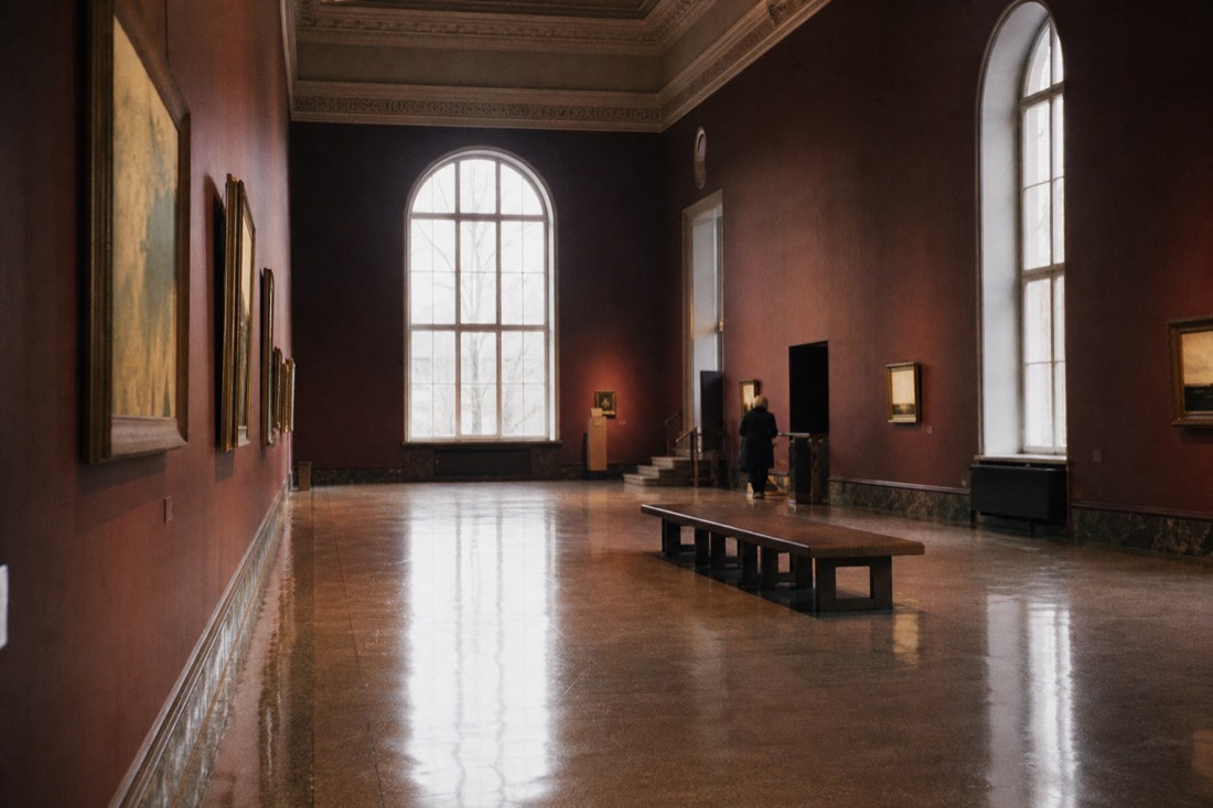 Dripping brick columns reflected in dark water inside Cisternerne beneath Sondermarken in Copenhagen